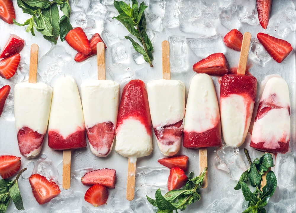 Strawberry yogurt popsicles on table