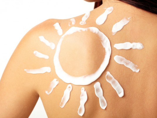 Woman's upper back with sunscreen