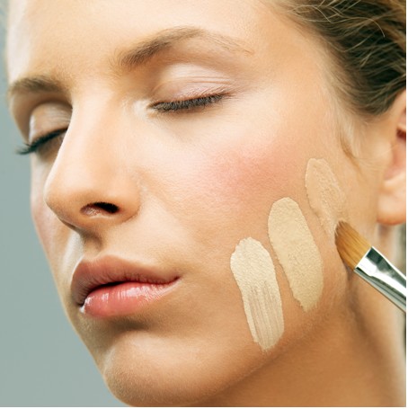 Woman applying foundation to skin