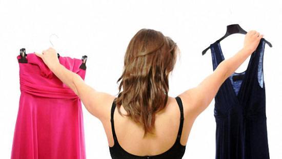 Woman choosing between two dresses