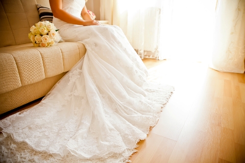 Long train of woman's white wedding dress