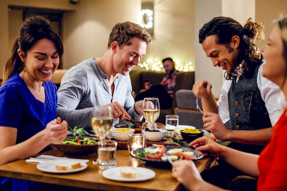 Two couples enjoying dinner together