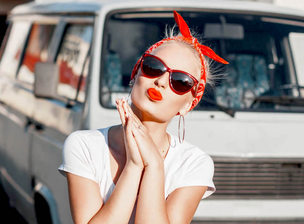 Happy woman with red lipstick and red hair bow