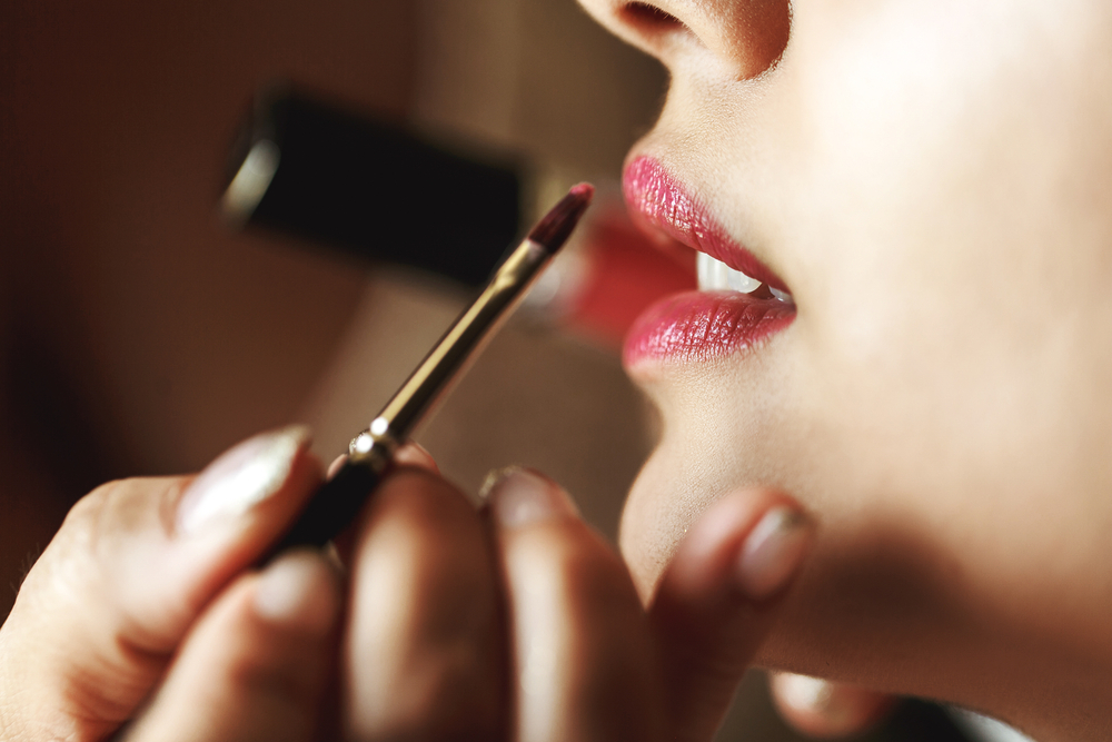 Woman applying lip color