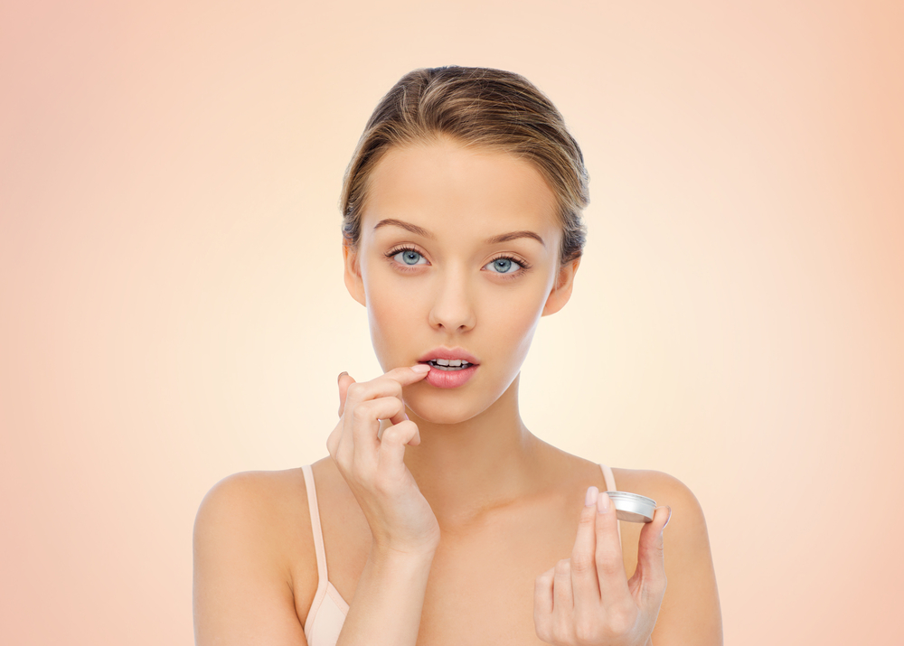 Woman applying lip balm