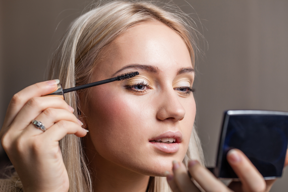 Woman applying mascara