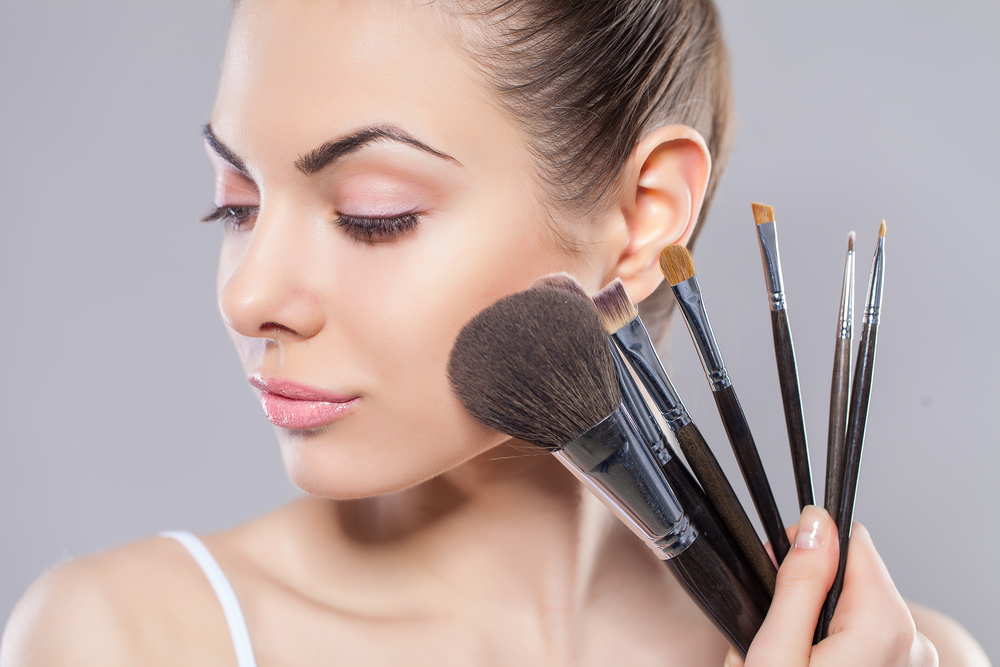 Woman holding makeup brushes