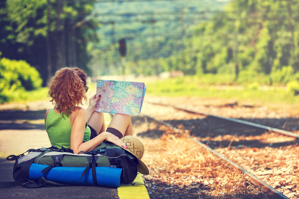 Woman looking at a map while traveling