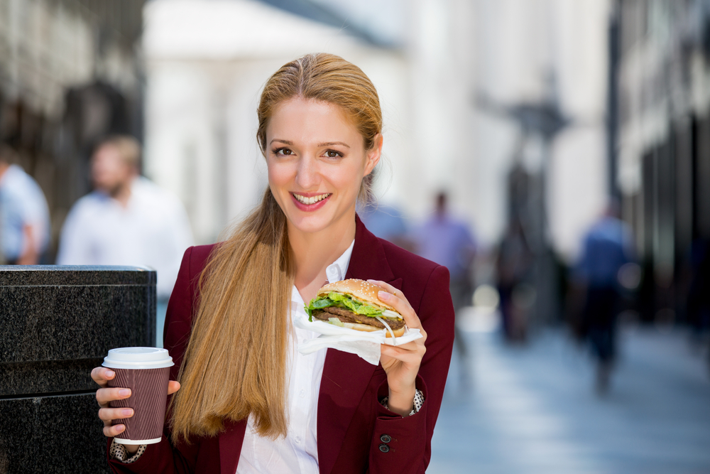 Woman having sandwich outdoors