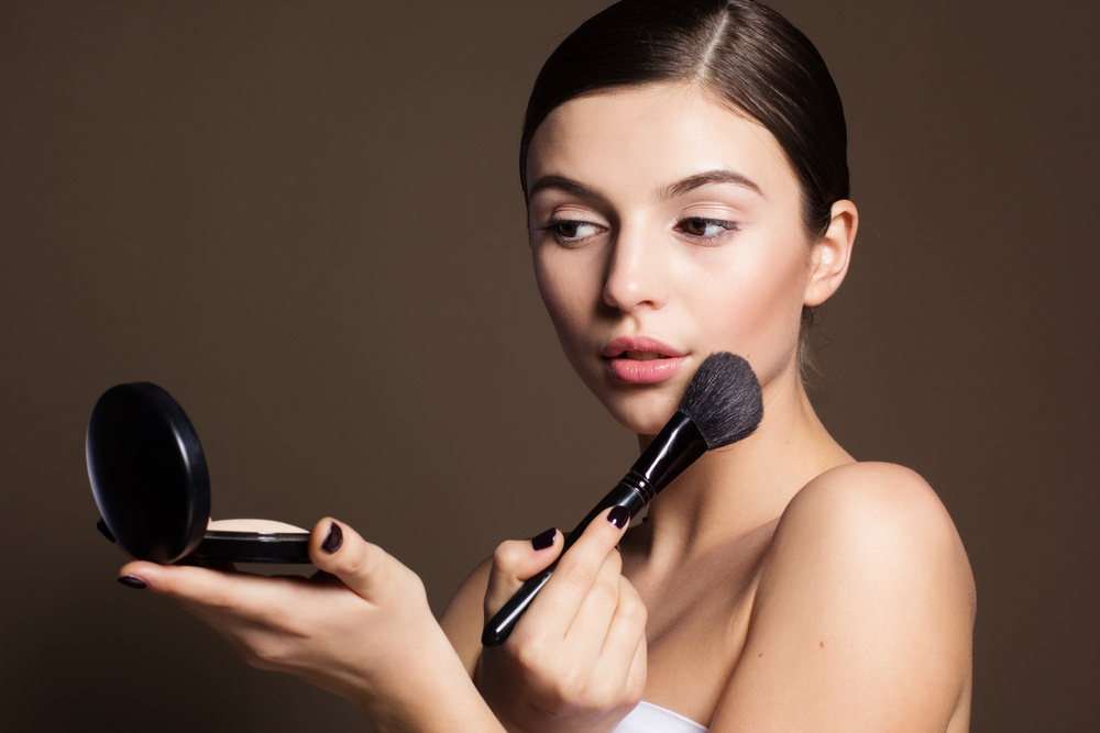 Woman applying makeup