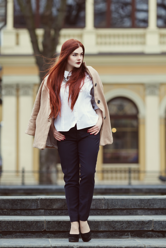 Stylish red-haired woman outdoors