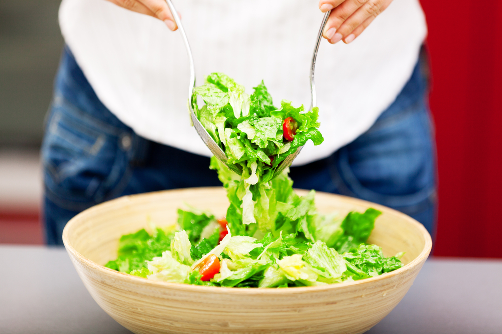 Woman tossing a salad