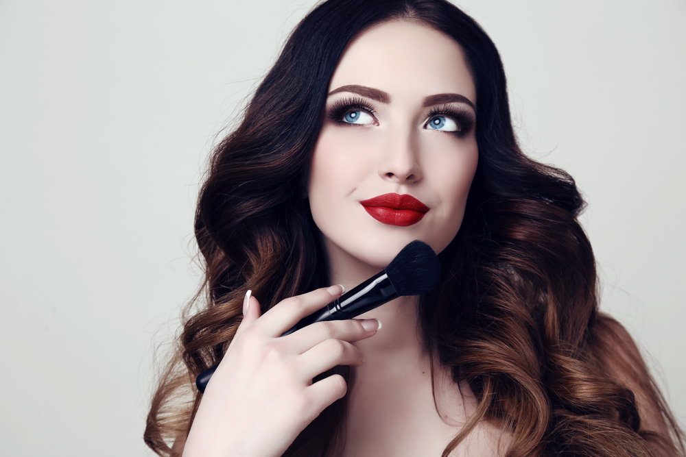 Woman holding a makeup brush