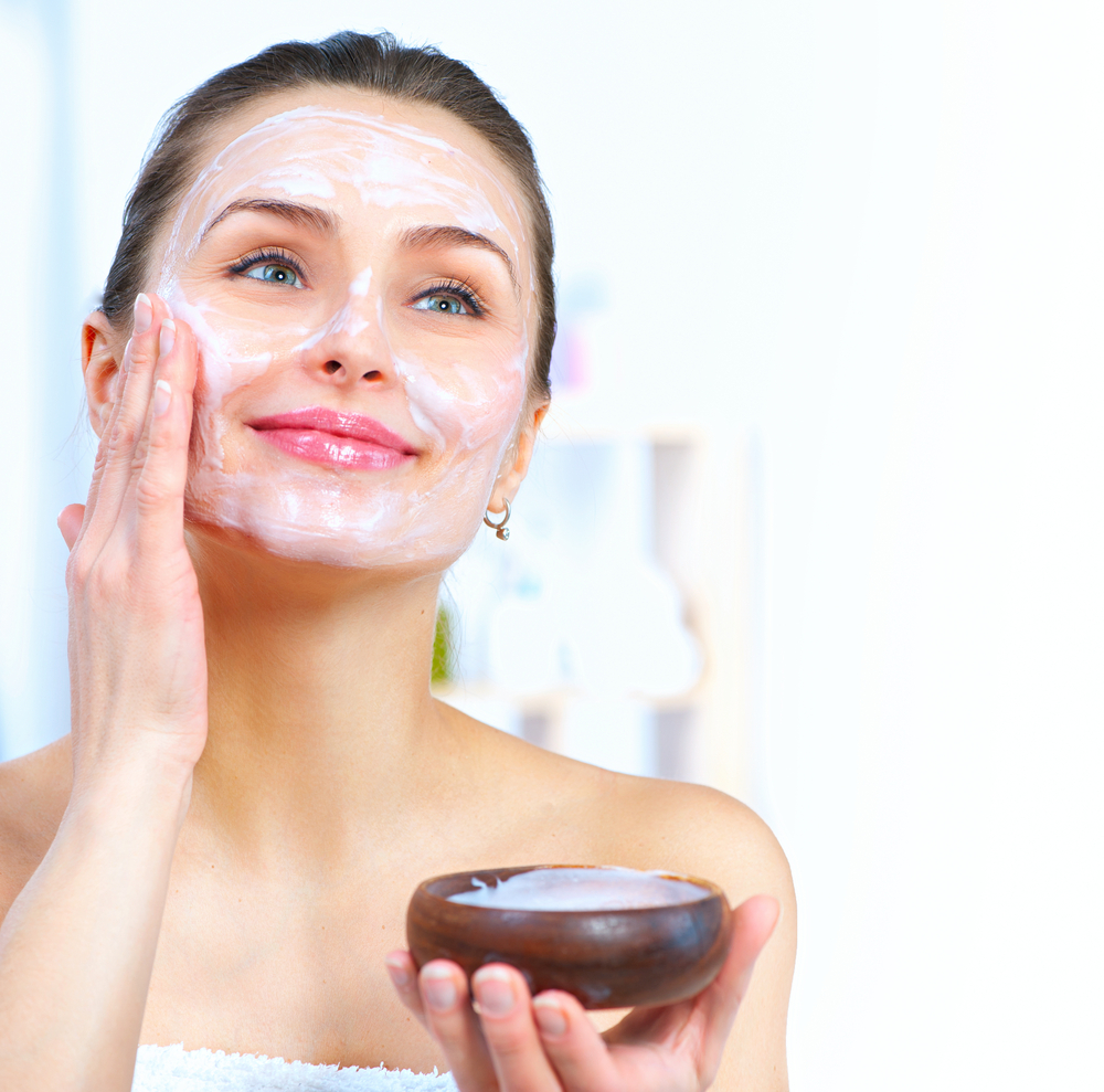 Woman applying a face mask