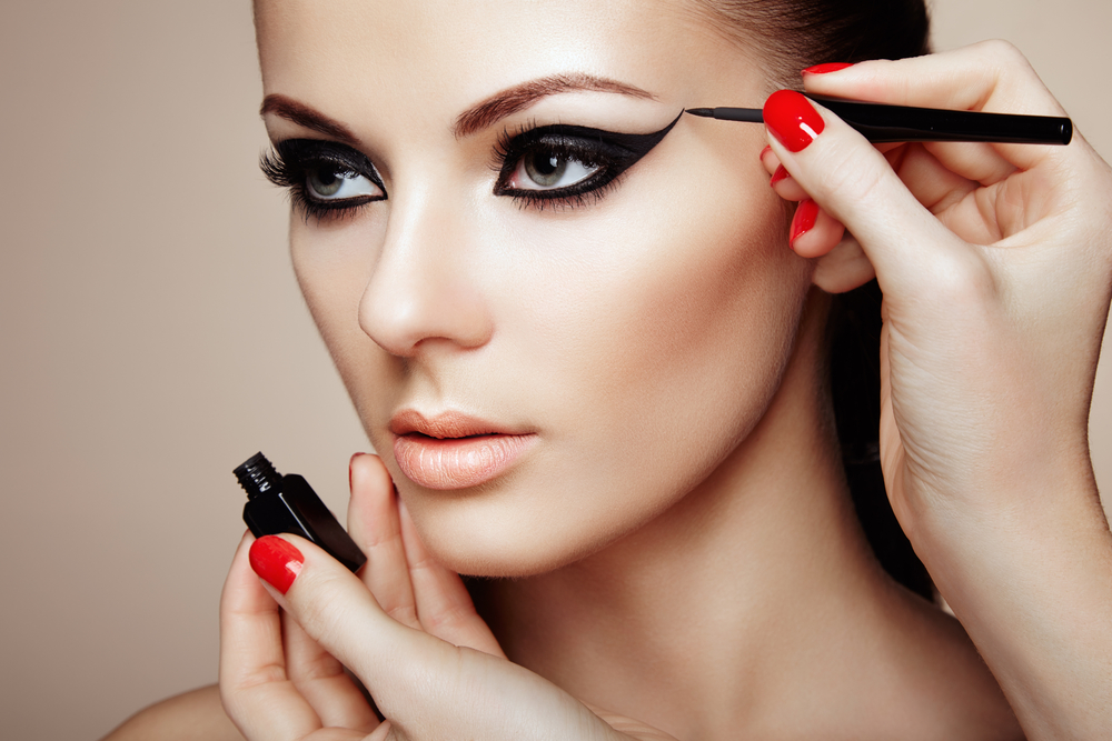 Women getting eyeliner applied