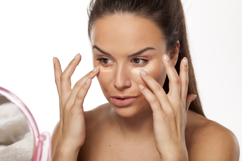 Woman applying liquid foundation