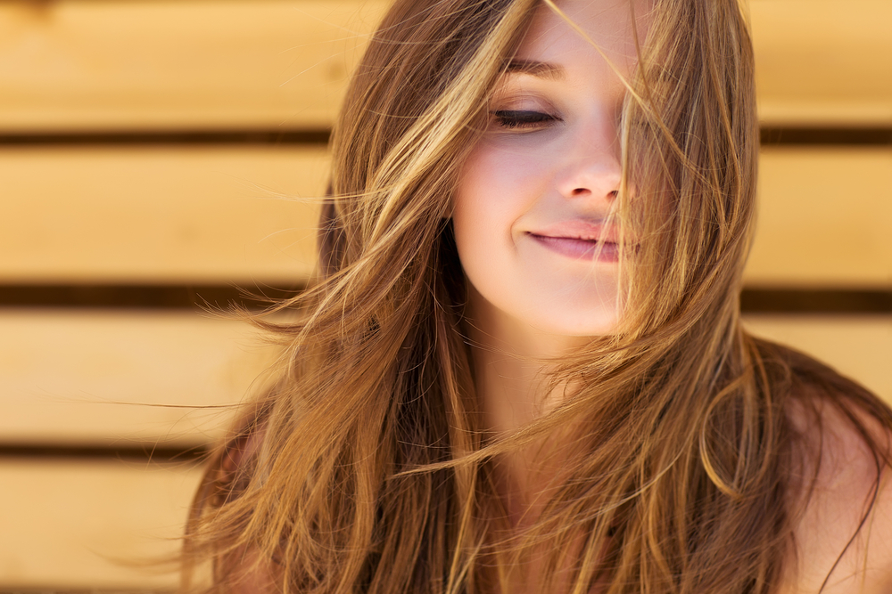 Woman with beautiful brown hair in the wind