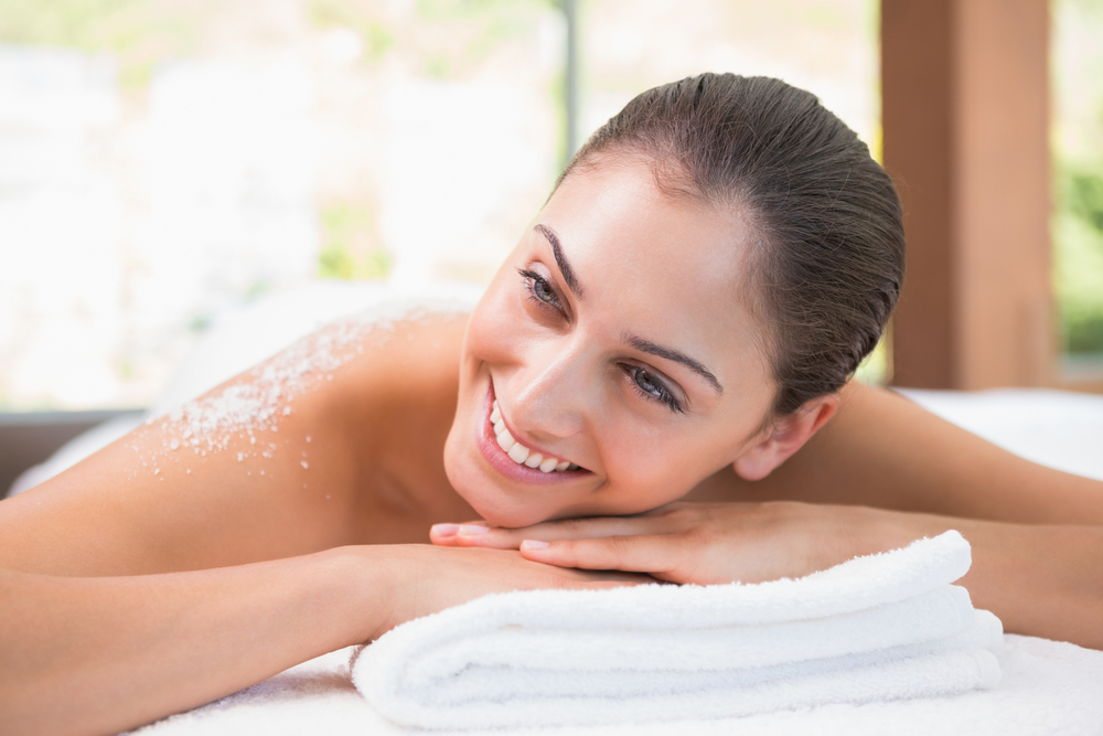 Women getting an exfoliation treatment