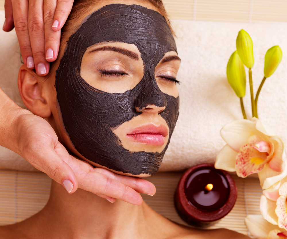 Woman applying mud mask