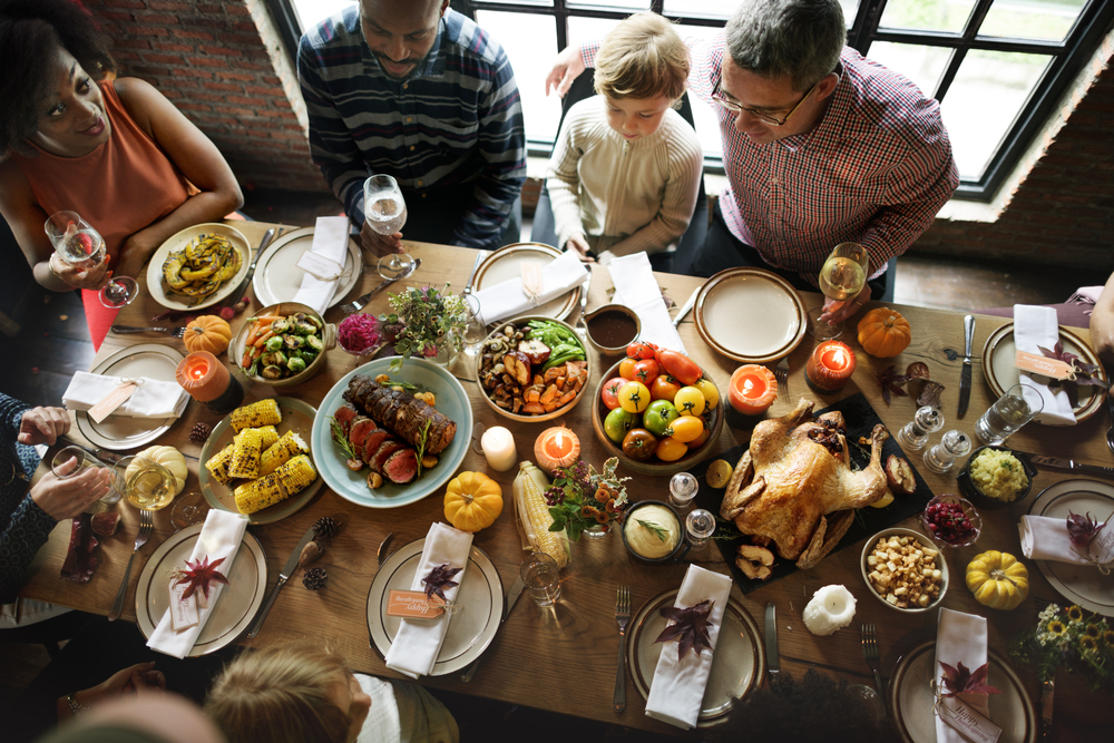 Friends enjoying assorted food on long table