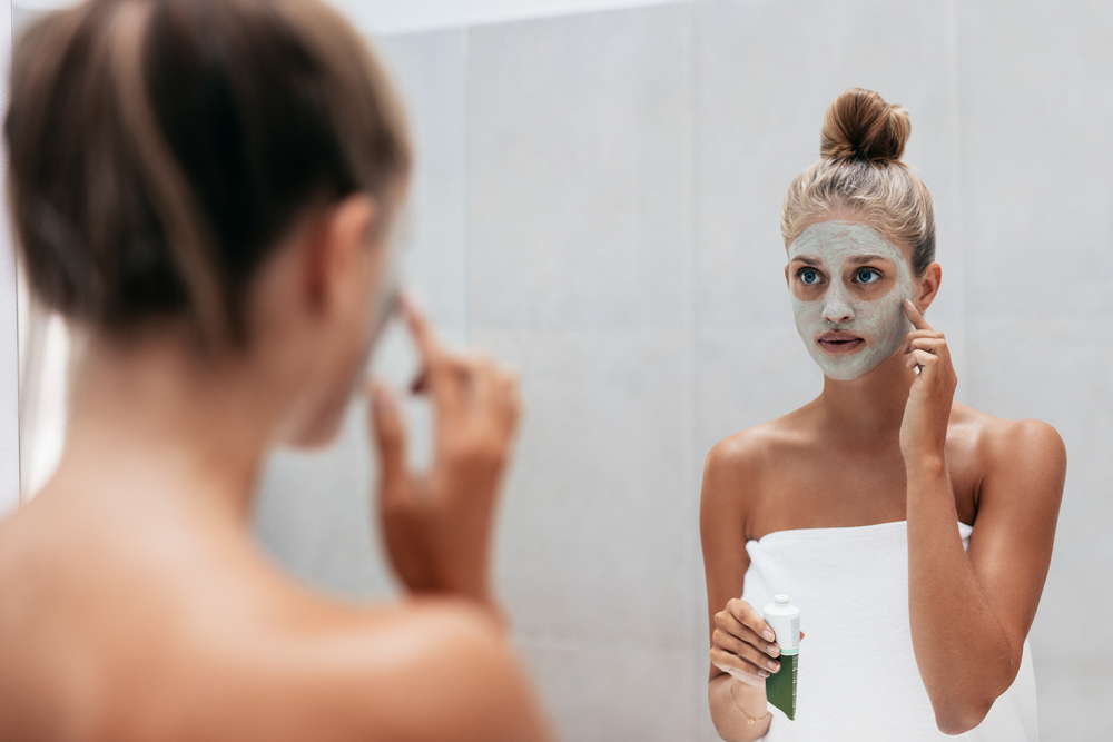 Woman applying face mask