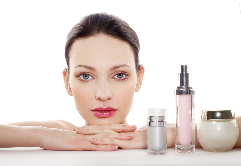 Woman with skincare products