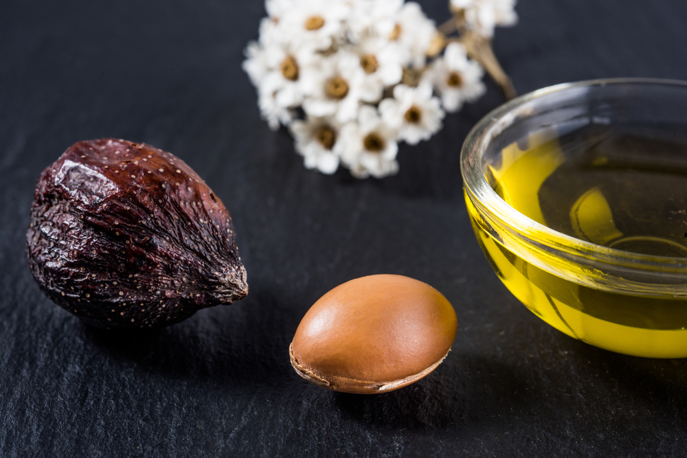 Argan oil and Argan nut on table