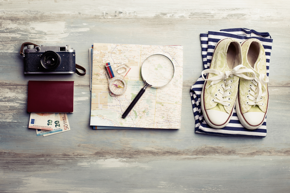 Travel items on wooden table