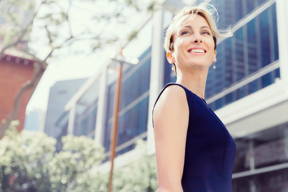 Woman smiling outside office