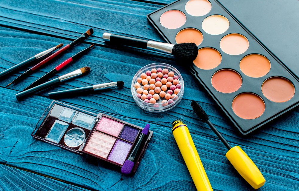 Makeup products on blue table