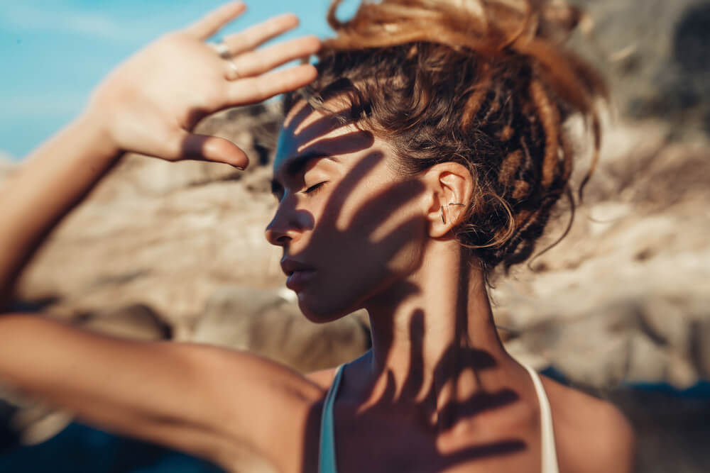 Woman covering her face from the sun