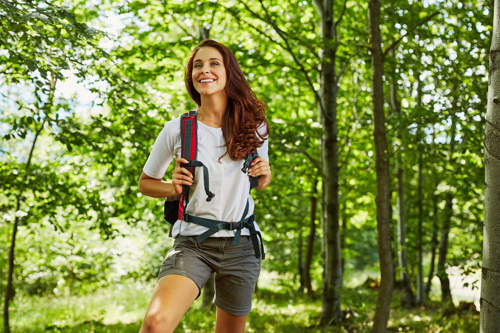 Woman hiking in green forest