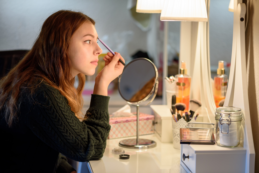 Woman applying makeup