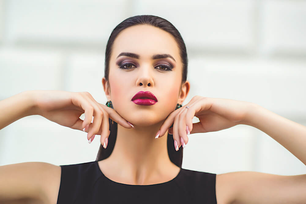 Brunette woman touching her face