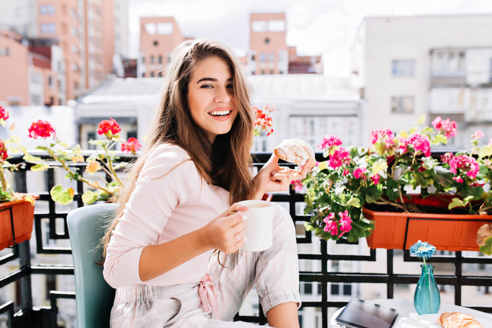 Woman enjoying coffee on balcony