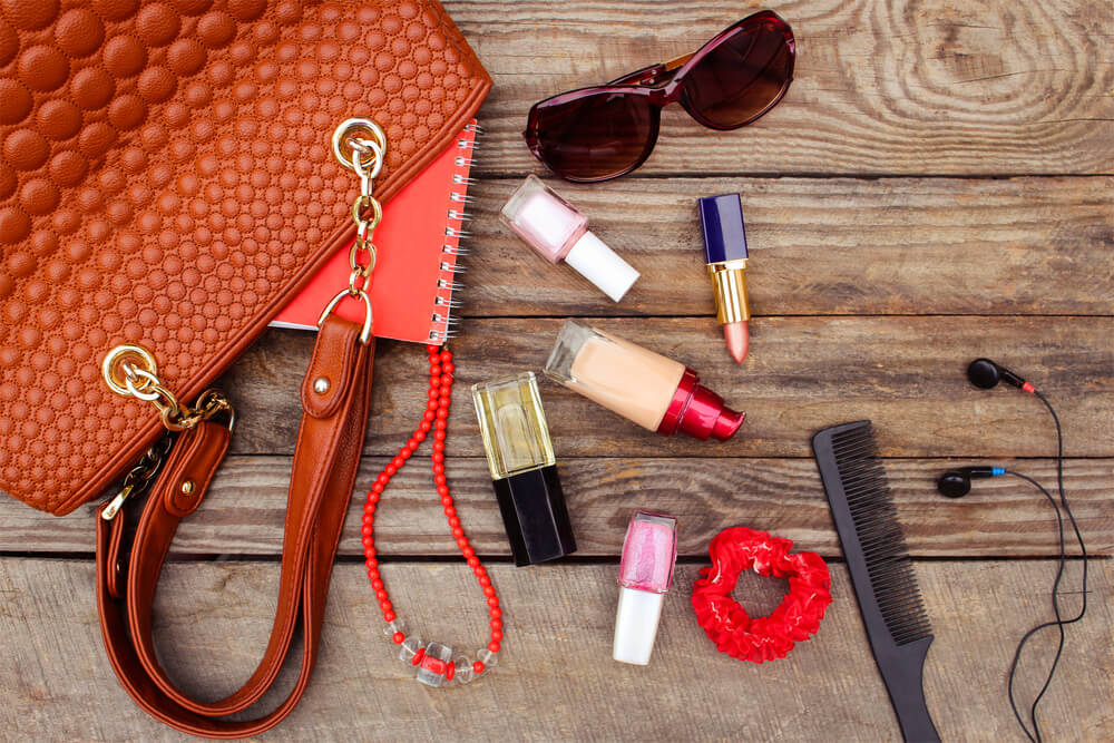 Makeup products scattered on table