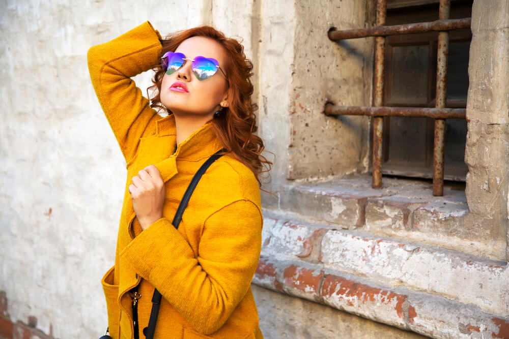 Woman in thick yellow coat outside