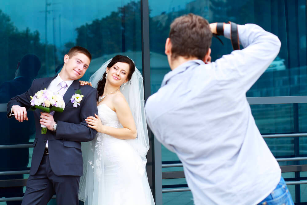 wedding photographer taking picture of couple