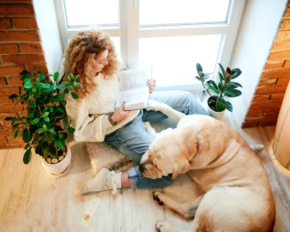 woman reading with dog