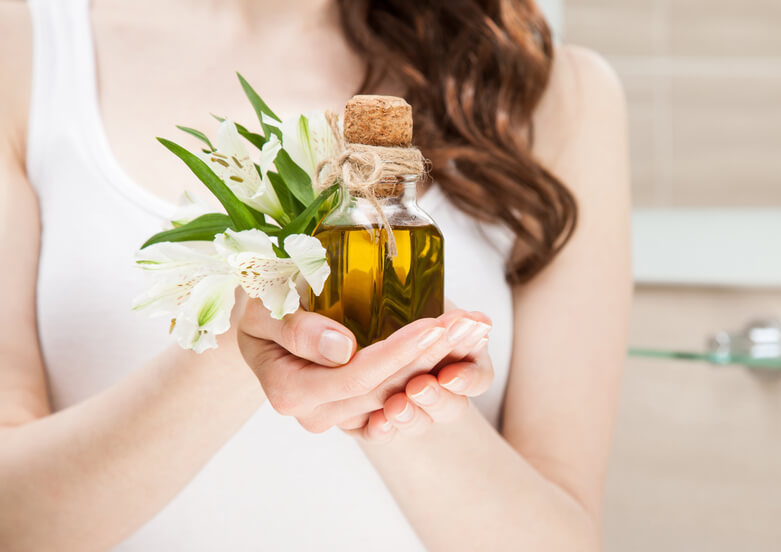 Woman holding botanical oil for hair