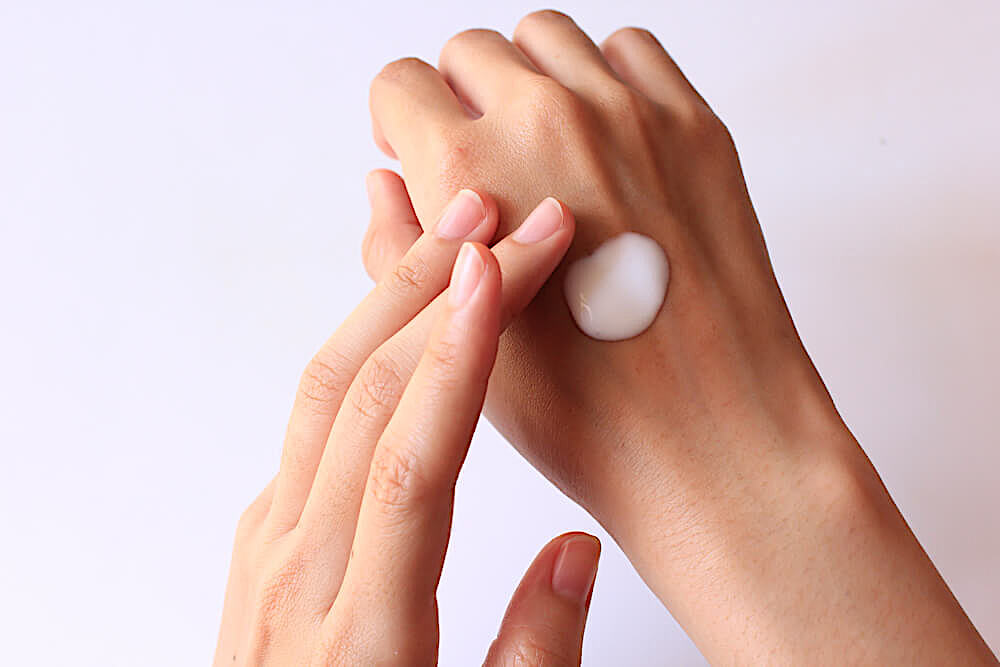 Applying lotion to the back of hand