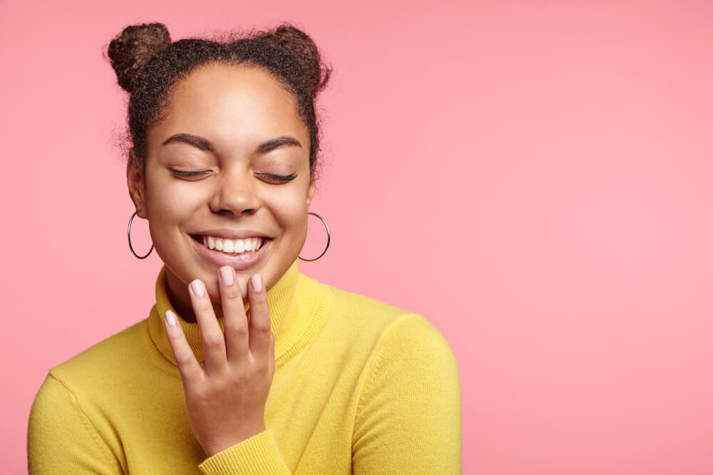 Smiling giggling woman with two hair buns