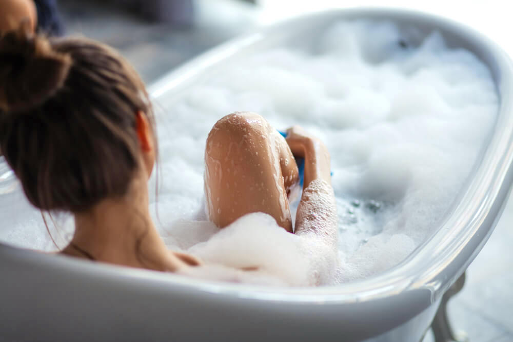 Woman enjoying a foamy bubble bath