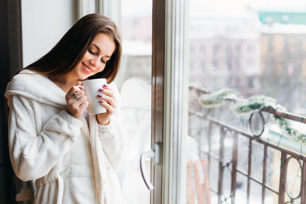 Smiling woman drinking a cup of tea