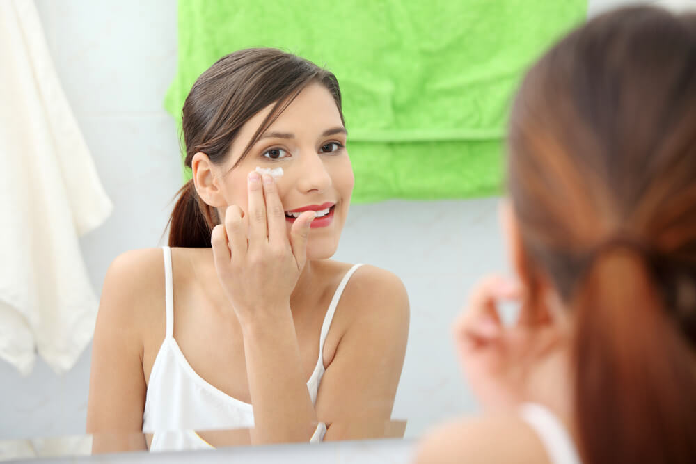 Applying eye cream under eyes 