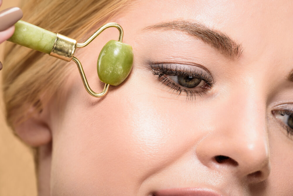 Massaging eye area with jade roller 