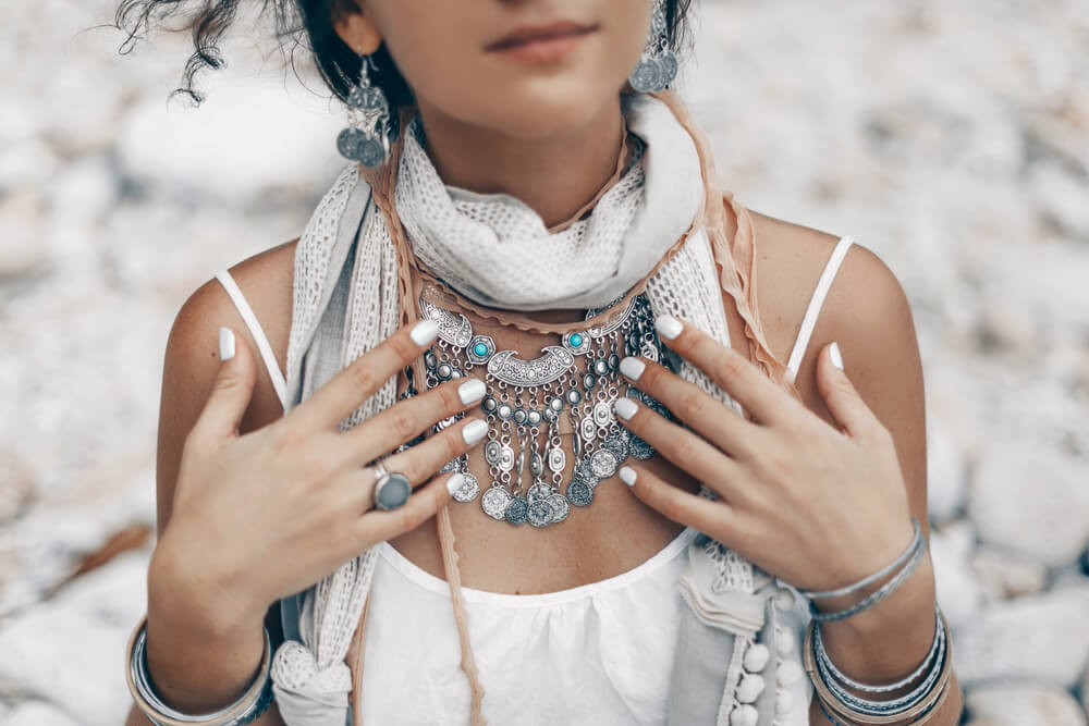 Unknown bohemian woman touching her necklaces