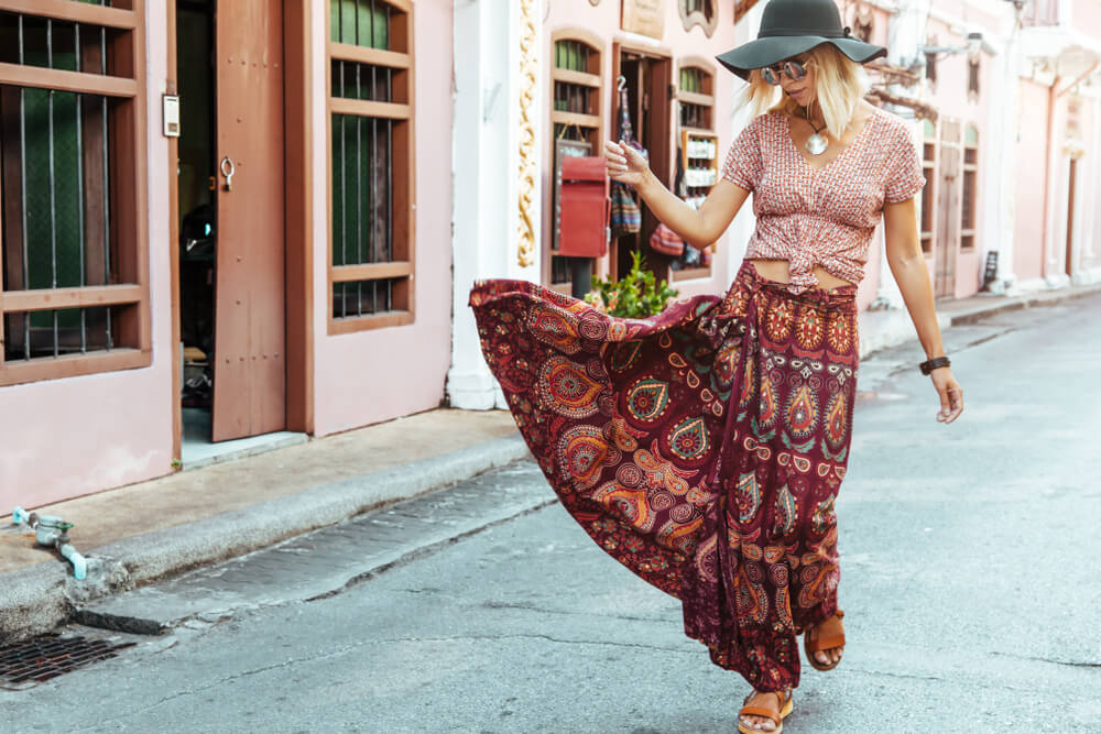 Woman in long maxi skirt walking down a European street