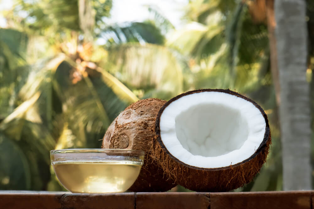 Coconut and coconut oil on table