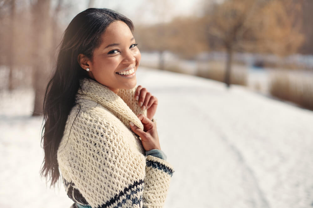 Woman smiling wearing sweater in winter